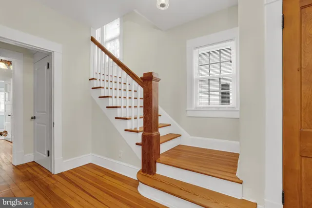 a view of entryway with wooden floor and stairs