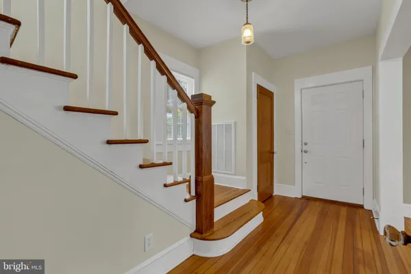 a view of entryway with wooden floor and stairs