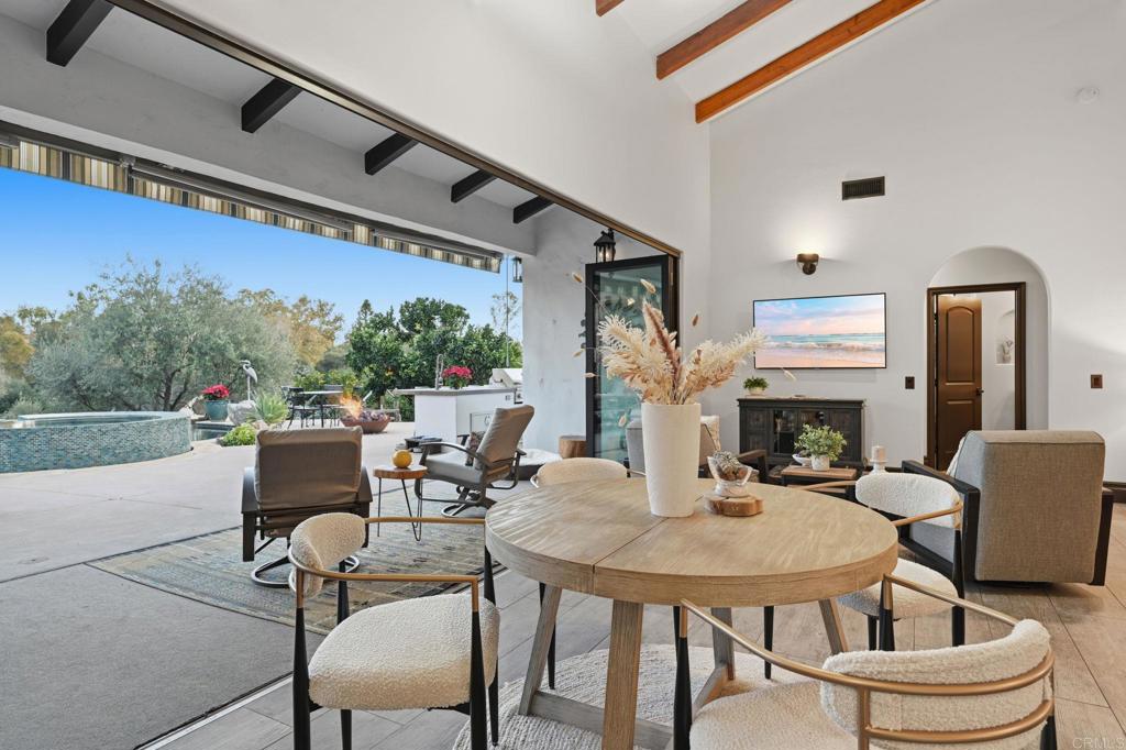 1111 Palomino Road Fallbrook, CA 92028 - Photo 21 of 64 a dining room with furniture and a fireplace