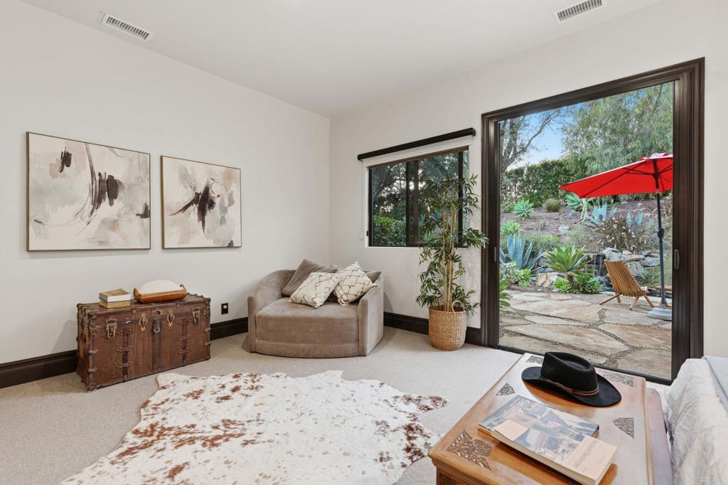 1111 Palomino Road Fallbrook, CA 92028 - Photo 27 of 64 a bedroom with a bed and wooden floor