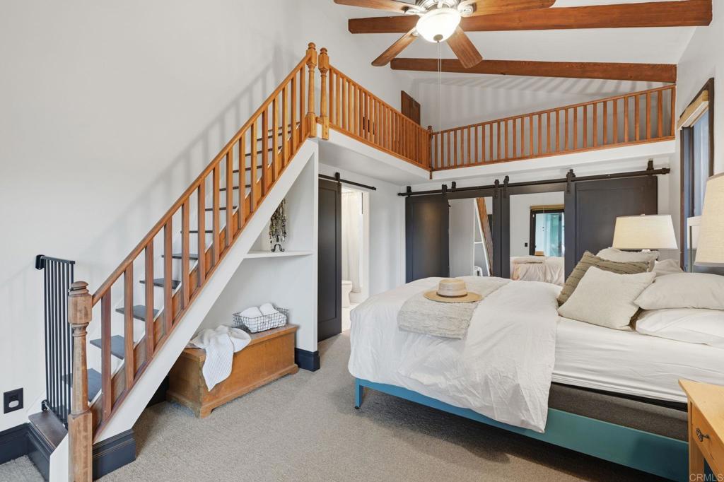1111 Palomino Road Fallbrook, CA 92028 - Photo 34 of 64 a living room with white walls stairs and a large window
