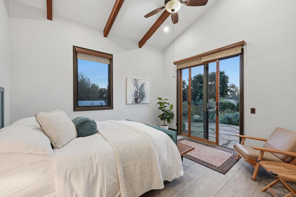 1111 Palomino Road Fallbrook, CA 92028 - Photo 37 of 64 a bedroom with a bed and a painting on the wall