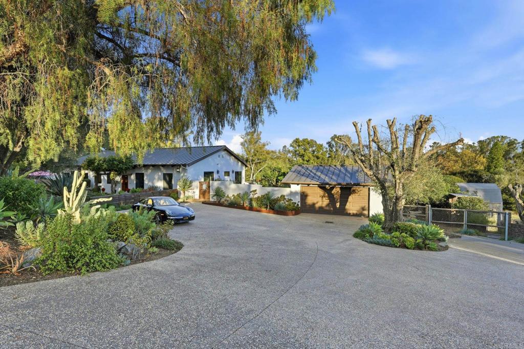 1111 Palomino Road Fallbrook, CA 92028 - Photo 5 of 64 a view of a house with table and chairs under an umbrella