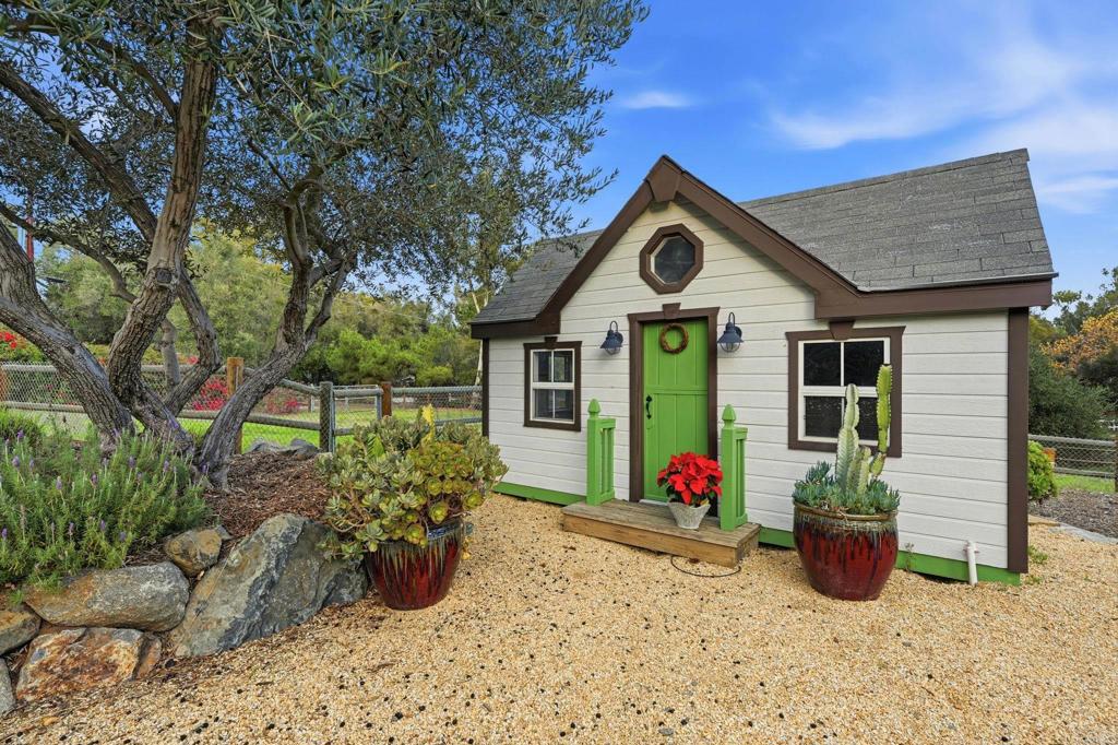 1111 Palomino Road Fallbrook, CA 92028 - Photo 56 of 64 a front view of a house with garden