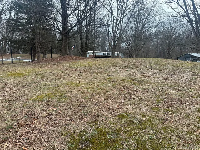a view of a yard covered with snow in front of house