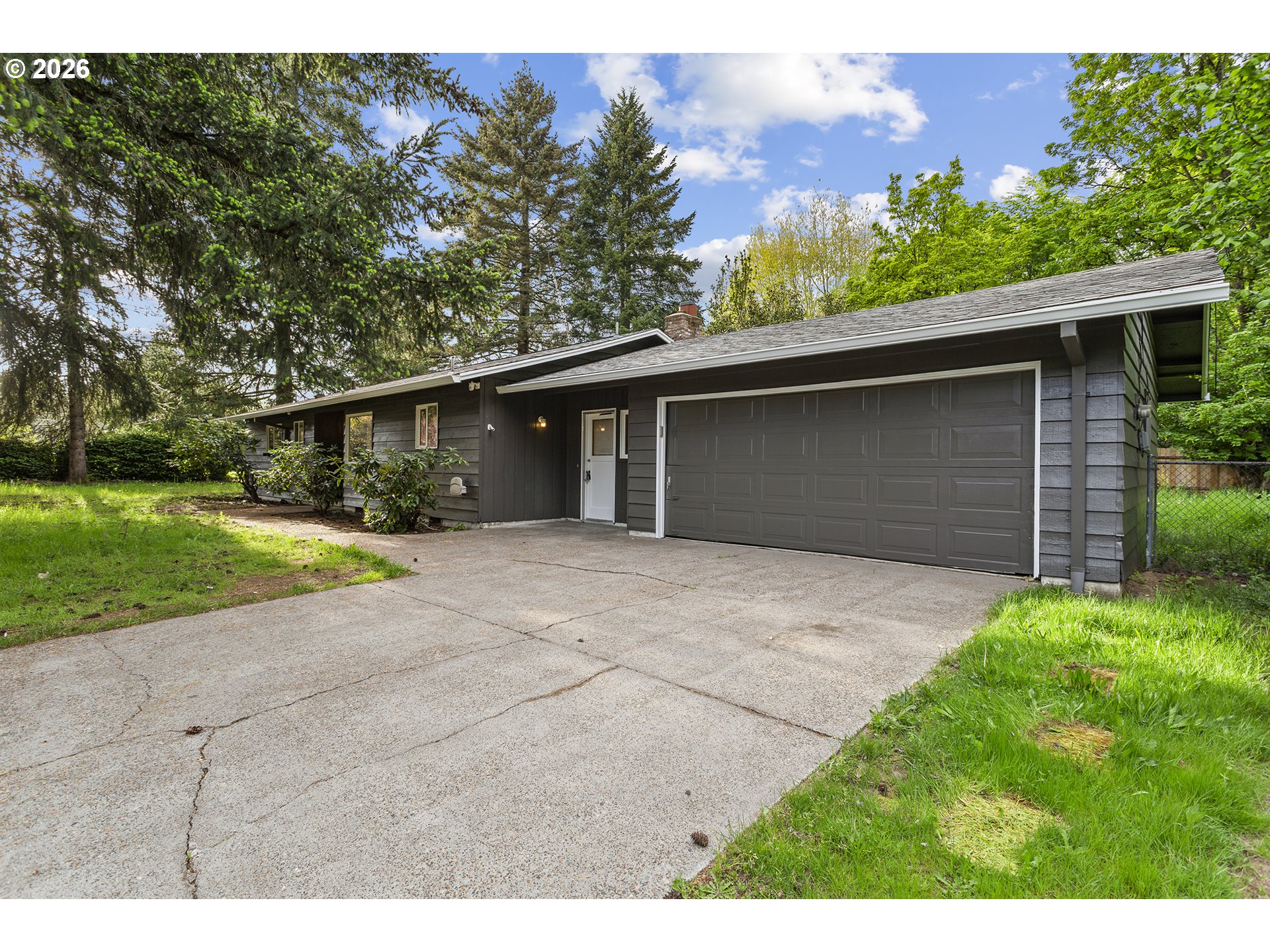 9375 Southwest Killarney Lane Tualatin, OR 97062 - Photo 1 of 25 a front view of a house with a yard and garage
