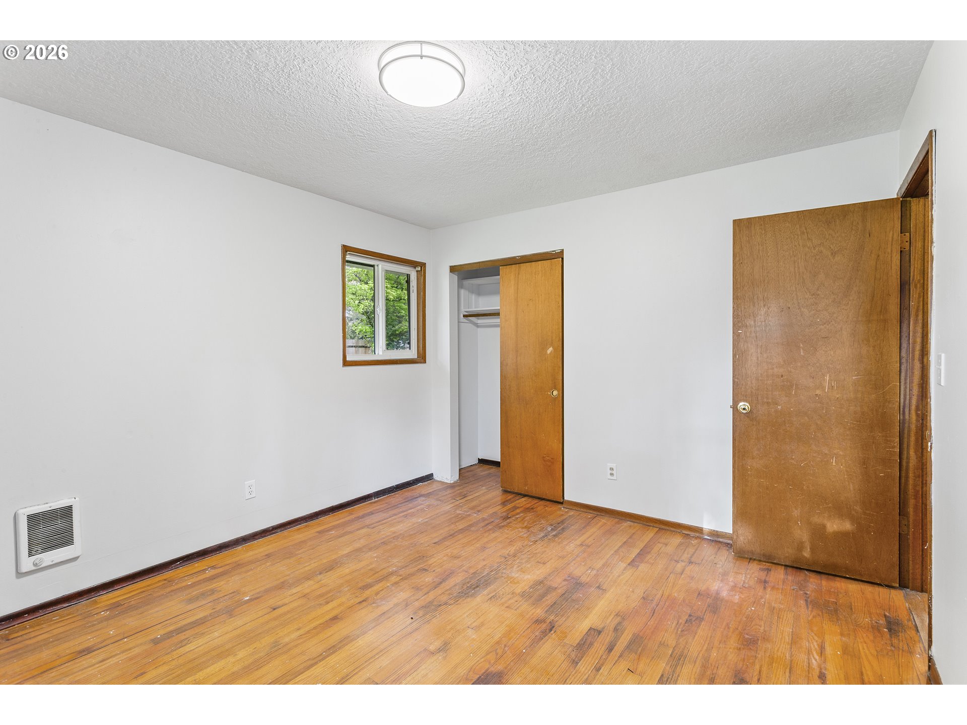 9375 Southwest Killarney Lane Tualatin, OR 97062 - Photo 14 of 25 a view of an empty room with wooden floor