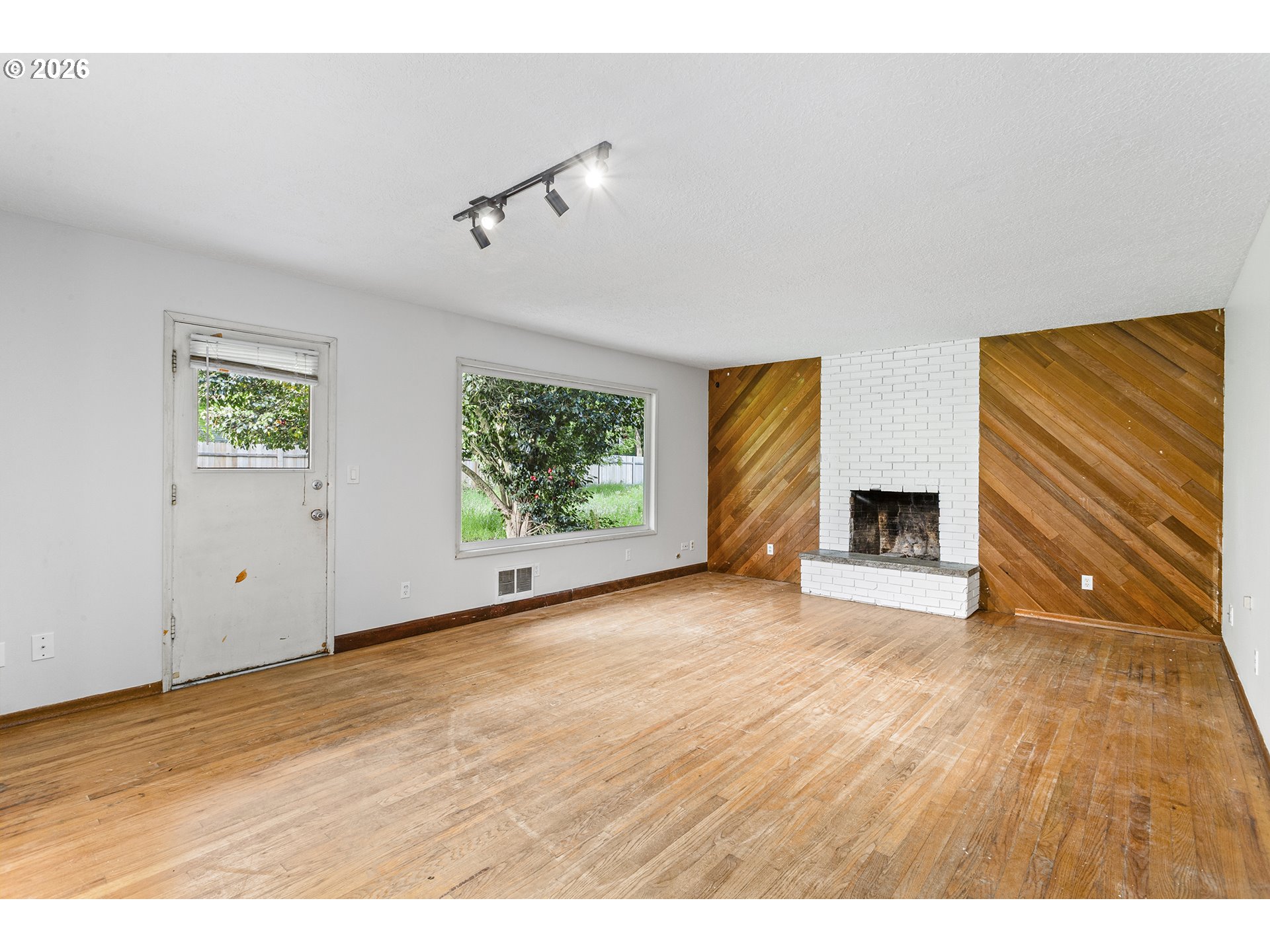 9375 Southwest Killarney Lane Tualatin, OR 97062 - Photo 4 of 25 a view of empty room with wooden floor and fan