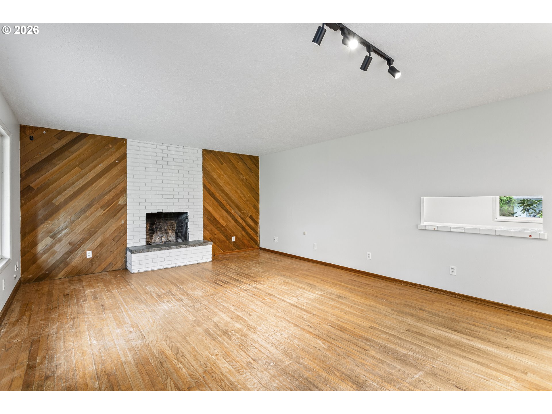 9375 Southwest Killarney Lane Tualatin, OR 97062 - Photo 9 of 25 a view of empty room with wooden floor and fireplace