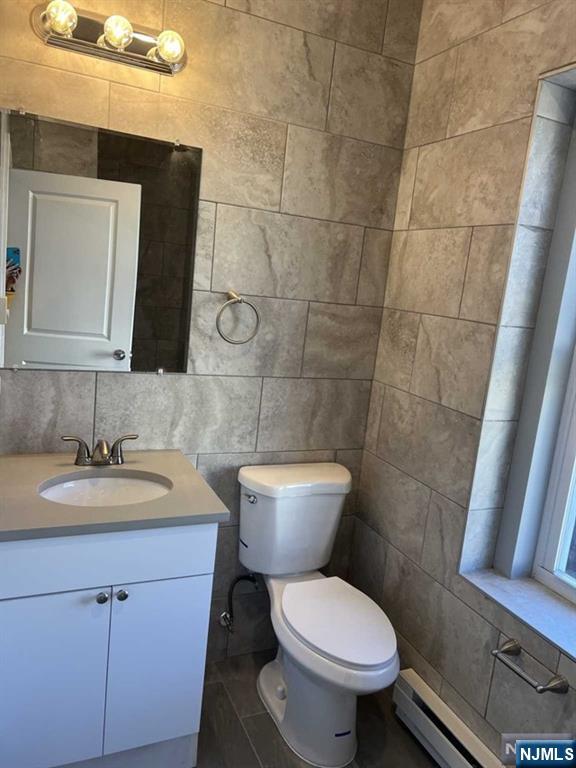 622 Warren Street, Unit 6 Harrison, NJ 07029 - Photo 3 of 5 a bathroom with a toilet sink and mirror