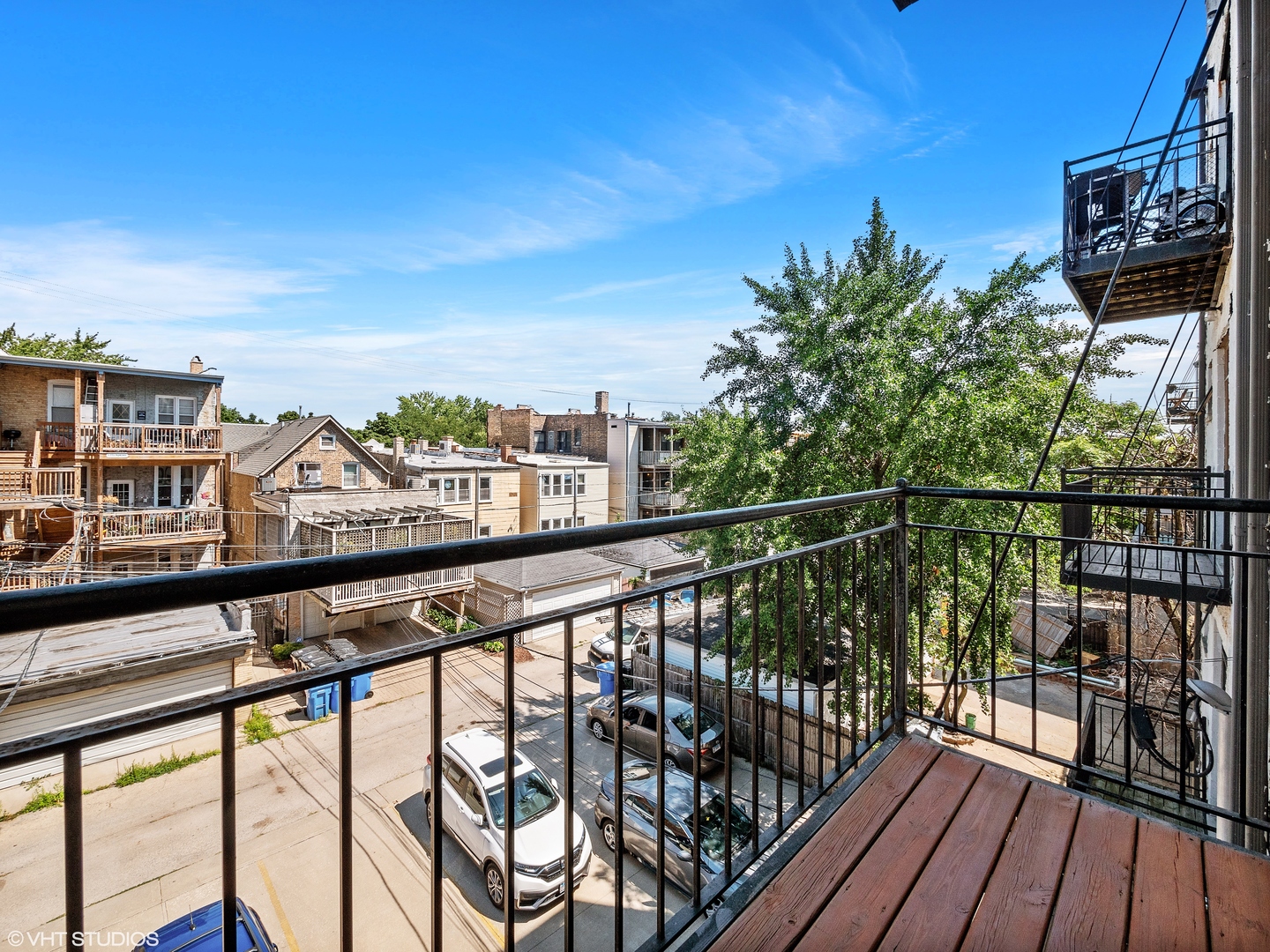 1428 West Irving Park Road, Unit 3 Chicago, IL 60613 - Photo 15 of 18 a view of a balcony with wooden floor and city view