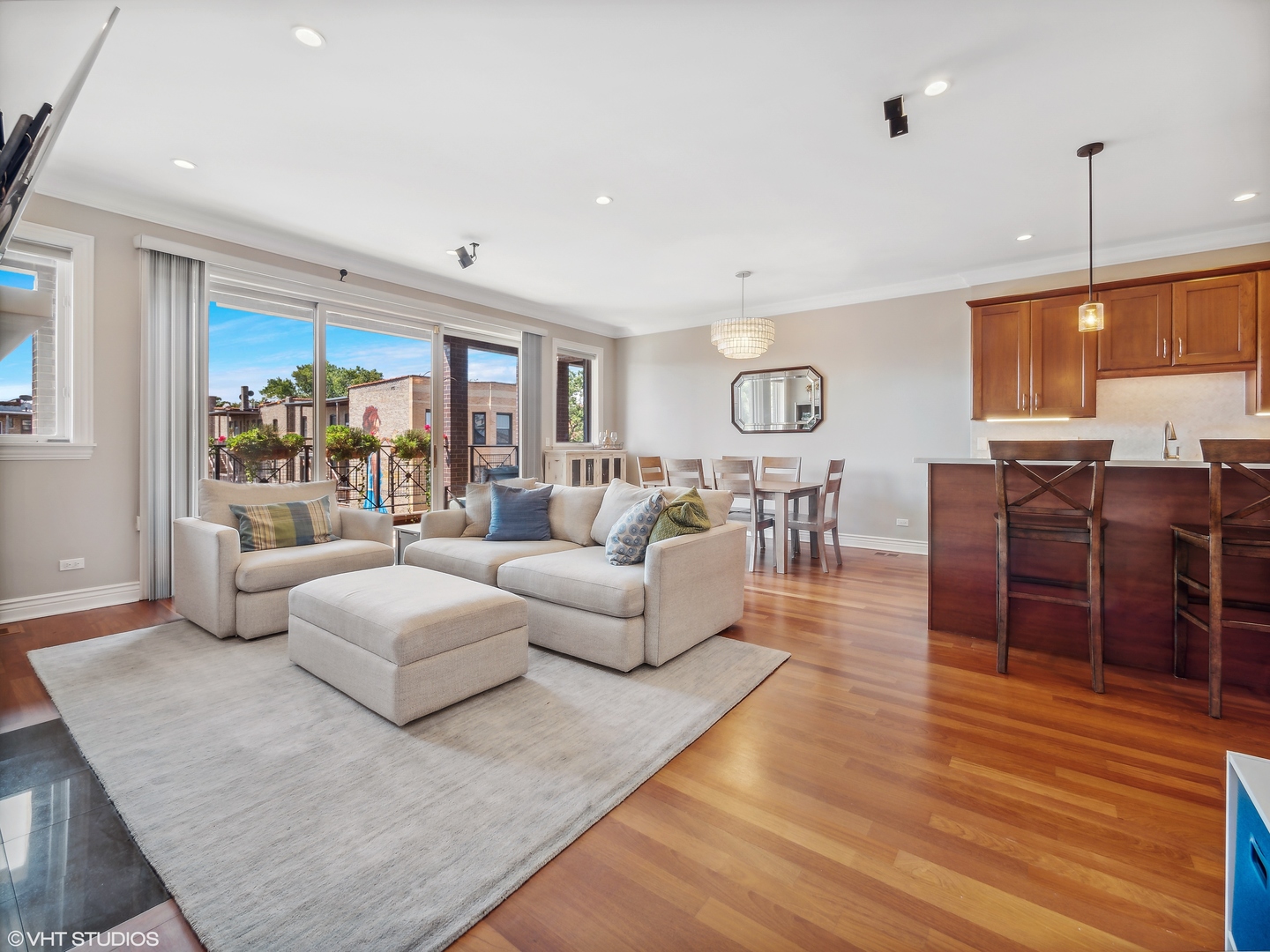 1428 West Irving Park Road, Unit 3 Chicago, IL 60613 - Photo 3 of 18 a living room with furniture a large window and wooden floor