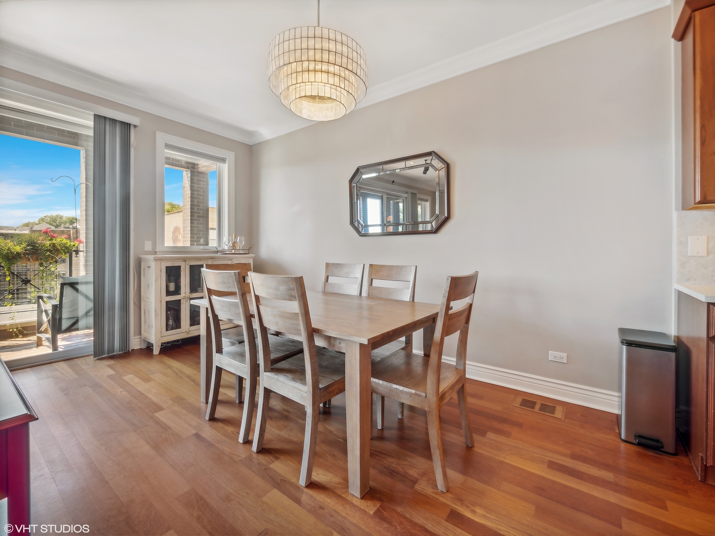 1428 West Irving Park Road, Unit 3 Chicago, IL 60613 - Photo 5 of 18 a view of a dining room with furniture wooden floor and chandelier