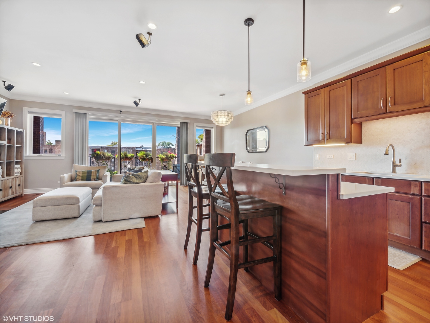 1428 West Irving Park Road, Unit 3 Chicago, IL 60613 - Photo 7 of 18 a living room with furniture a wooden floor and kitchen view