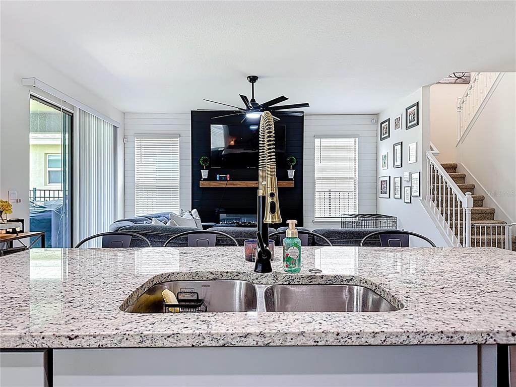 16632 Point Rock Drive Winter Garden, FL 34787 - Photo 16 of 74 a kitchen with granite countertop a sink and a wooden floor