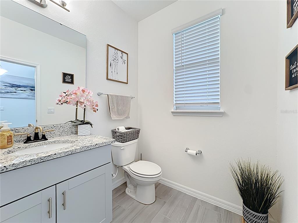 16632 Point Rock Drive Winter Garden, FL 34787 - Photo 27 of 74 a bathroom with a granite countertop toilet sink and mirror