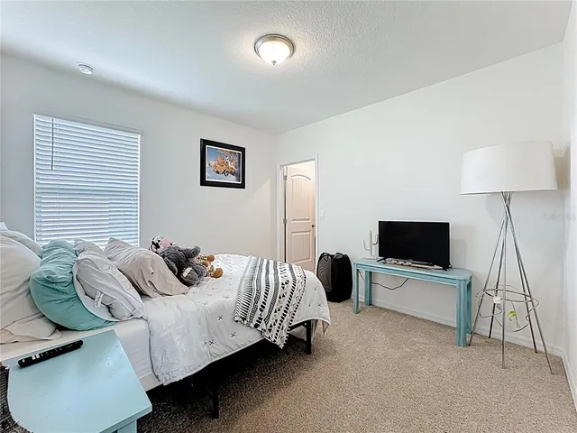 a large bathroom with a granite countertop double vanity sink and a mirror