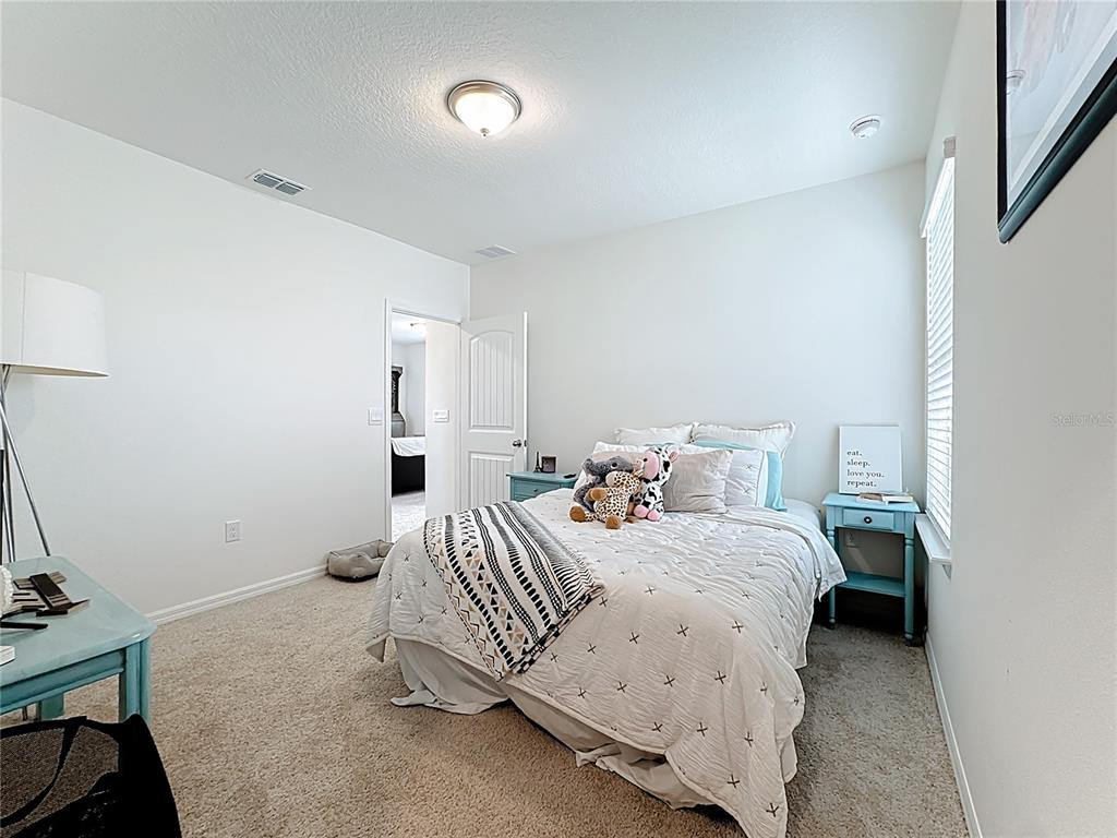 16632 Point Rock Drive Winter Garden, FL 34787 - Photo 31 of 74 a bedroom with a bed and a window