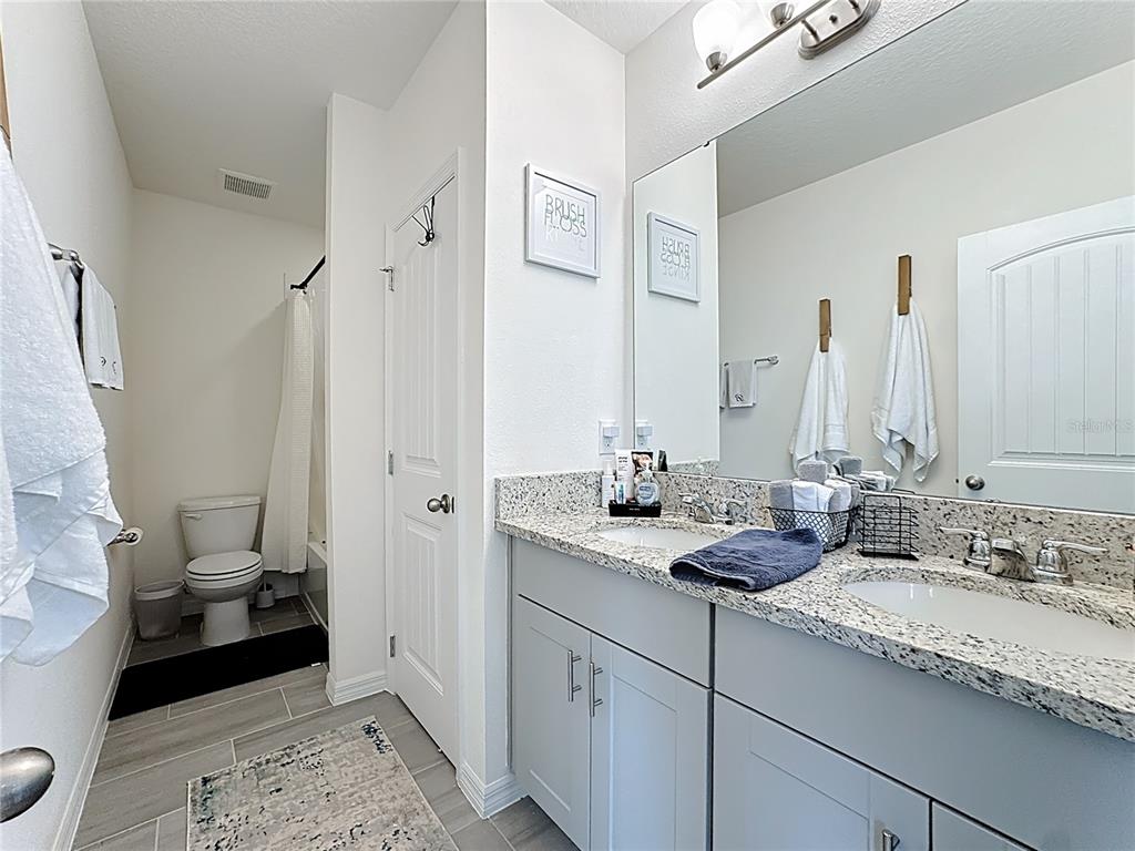 16632 Point Rock Drive Winter Garden, FL 34787 - Photo 32 of 74 a bathroom with a granite countertop sink and a mirror