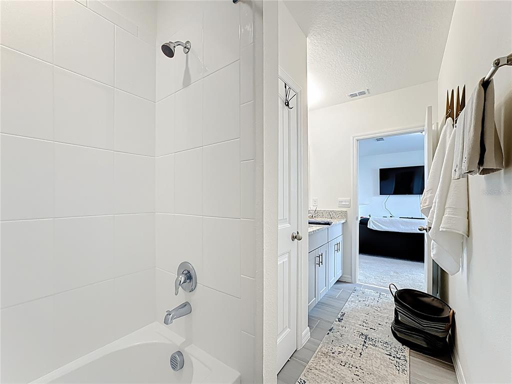 16632 Point Rock Drive Winter Garden, FL 34787 - Photo 34 of 74 a bathroom with a tub a sink and a mirror