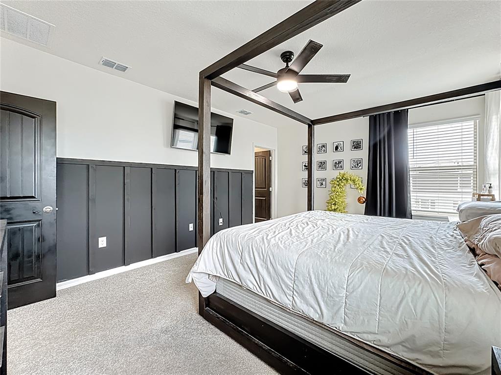 16632 Point Rock Drive Winter Garden, FL 34787 - Photo 35 of 74 a bedroom with a bed and a chandelier