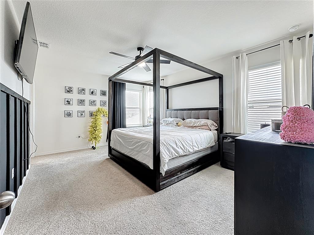 16632 Point Rock Drive Winter Garden, FL 34787 - Photo 36 of 74 a bedroom with a bed bed tv and a window