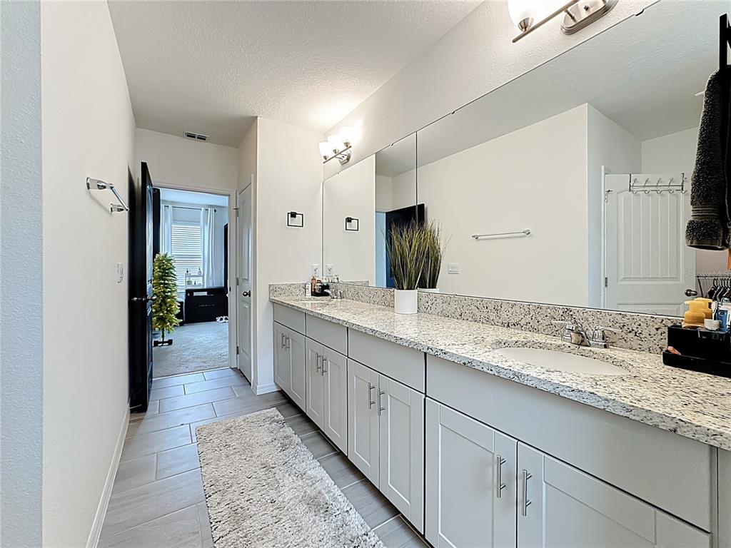 16632 Point Rock Drive Winter Garden, FL 34787 - Photo 40 of 74 a large white kitchen with a sink and dish washer