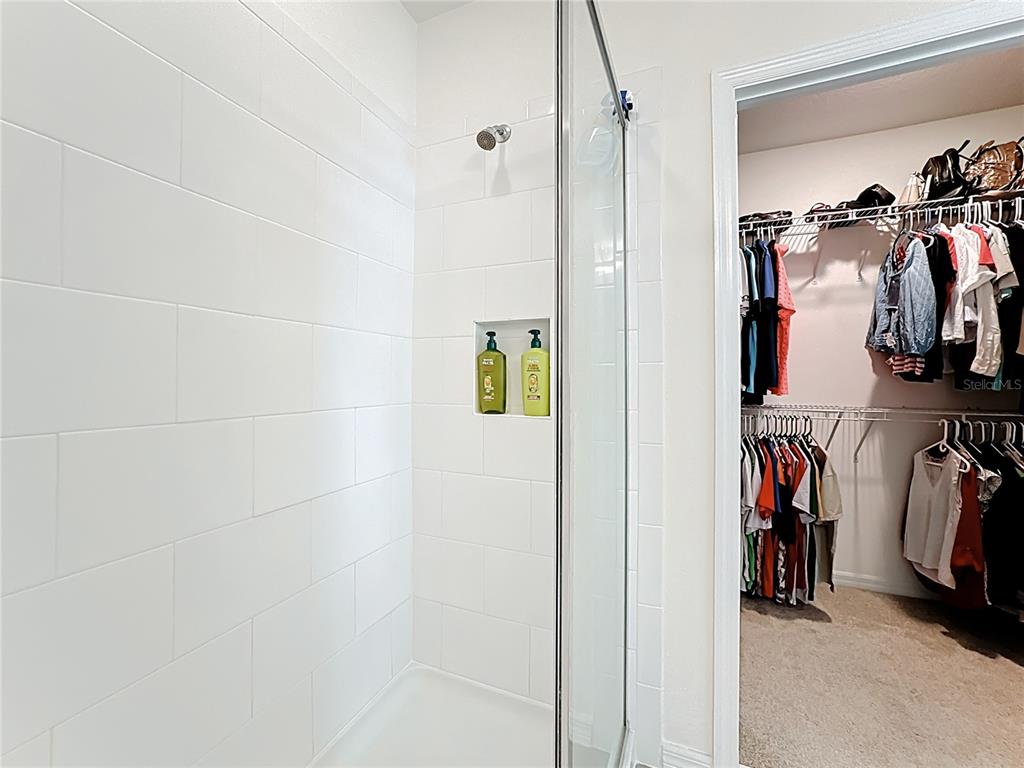 16632 Point Rock Drive Winter Garden, FL 34787 - Photo 41 of 74 a view of walk in closet with clothes and shoes