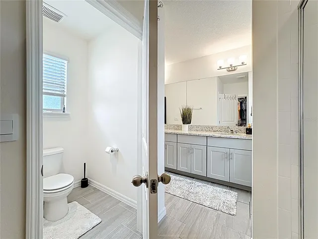 an aerial view of multiple houses with a big yard