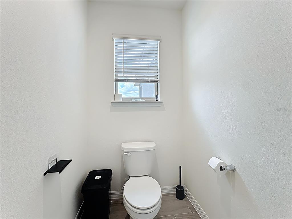 16632 Point Rock Drive Winter Garden, FL 34787 - Photo 43 of 74 a white toilet sitting in a bathroom next to a window