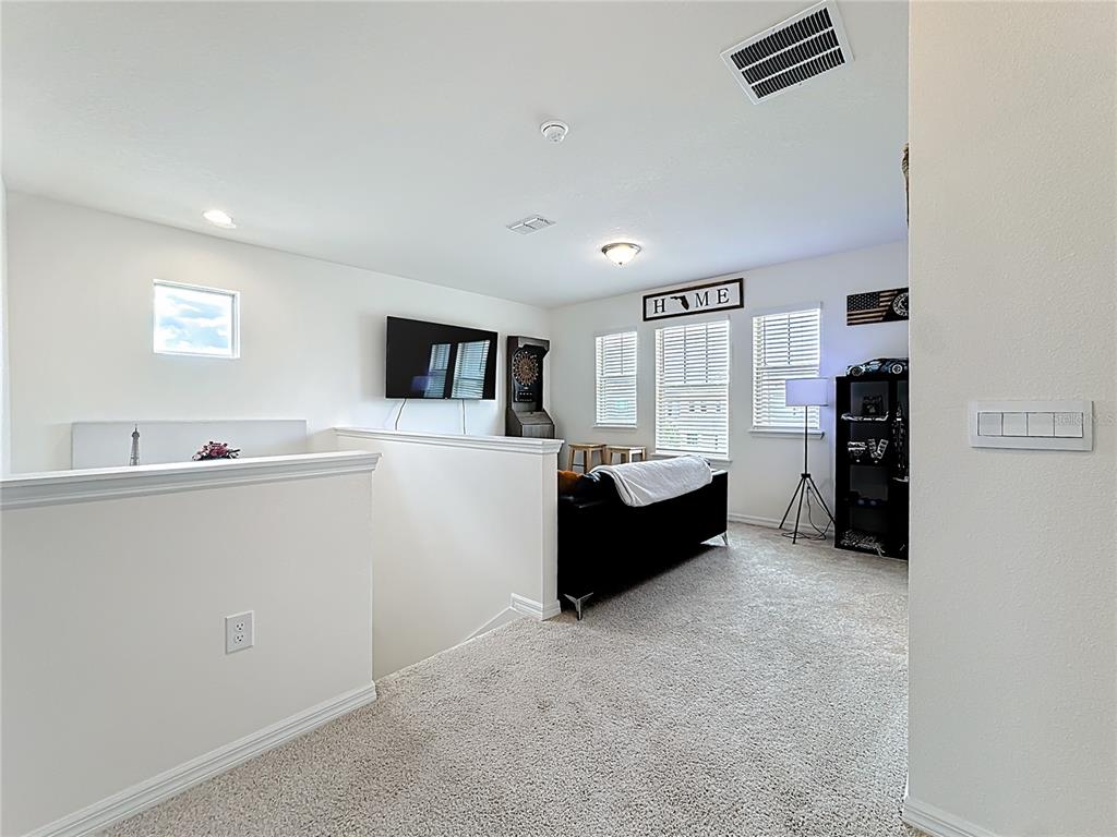 16632 Point Rock Drive Winter Garden, FL 34787 - Photo 44 of 74 a living room with furniture and a flat screen tv