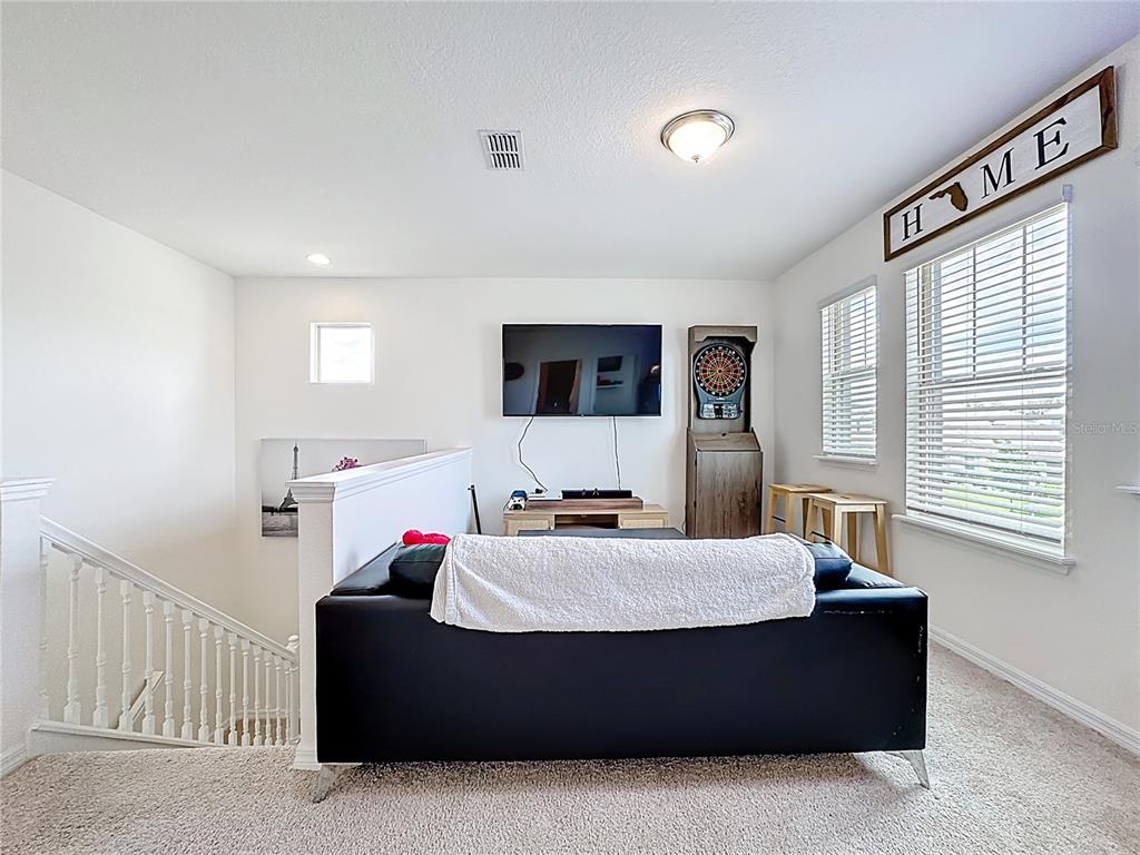 16632 Point Rock Drive Winter Garden, FL 34787 - Photo 45 of 74 a living room with furniture and a flat screen tv