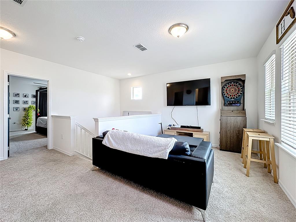 16632 Point Rock Drive Winter Garden, FL 34787 - Photo 46 of 74 a living room with furniture and a flat screen tv