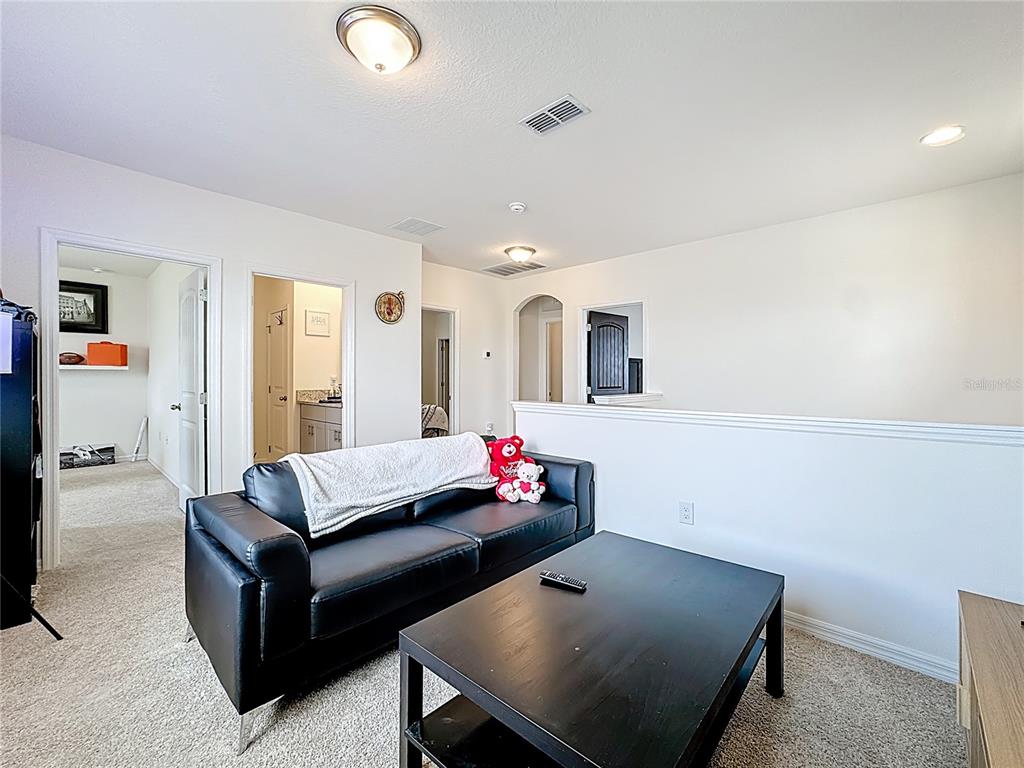 16632 Point Rock Drive Winter Garden, FL 34787 - Photo 47 of 74 a living room with furniture and a flat screen tv