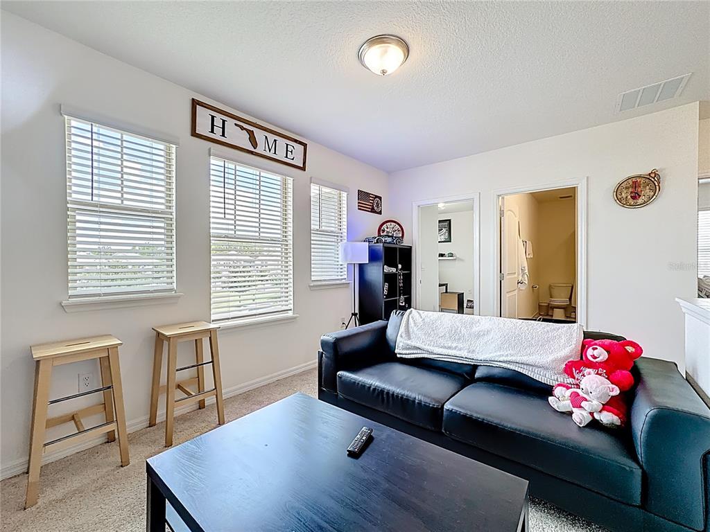 16632 Point Rock Drive Winter Garden, FL 34787 - Photo 48 of 74 a living room with furniture and a window