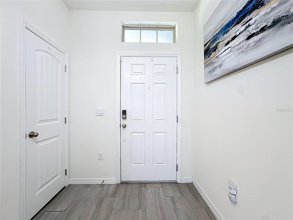 16632 Point Rock Drive Winter Garden, FL 34787 - Photo 6 of 74 a view of a livingroom with wooden floor and a window