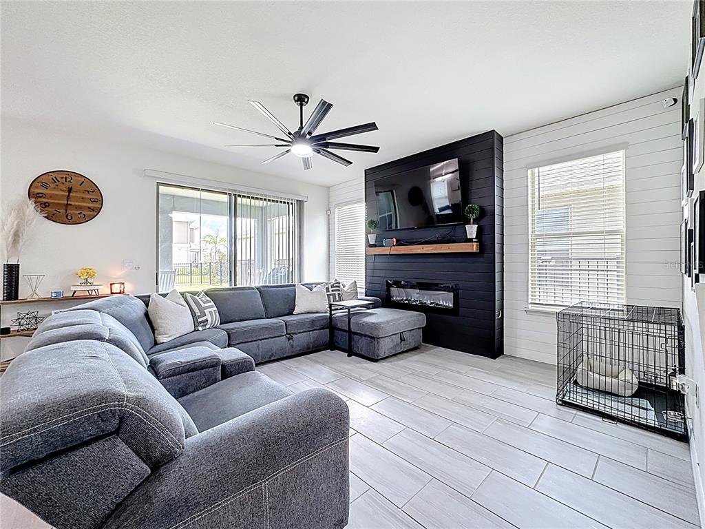 16632 Point Rock Drive Winter Garden, FL 34787 - Photo 7 of 74 a living room with furniture and a flat screen tv