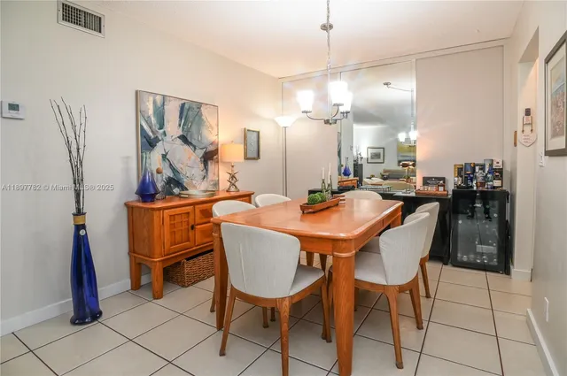 a hallway with a black white checkered floor and a large mirror on a wall