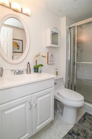 a view of a park that has a sign board large trees