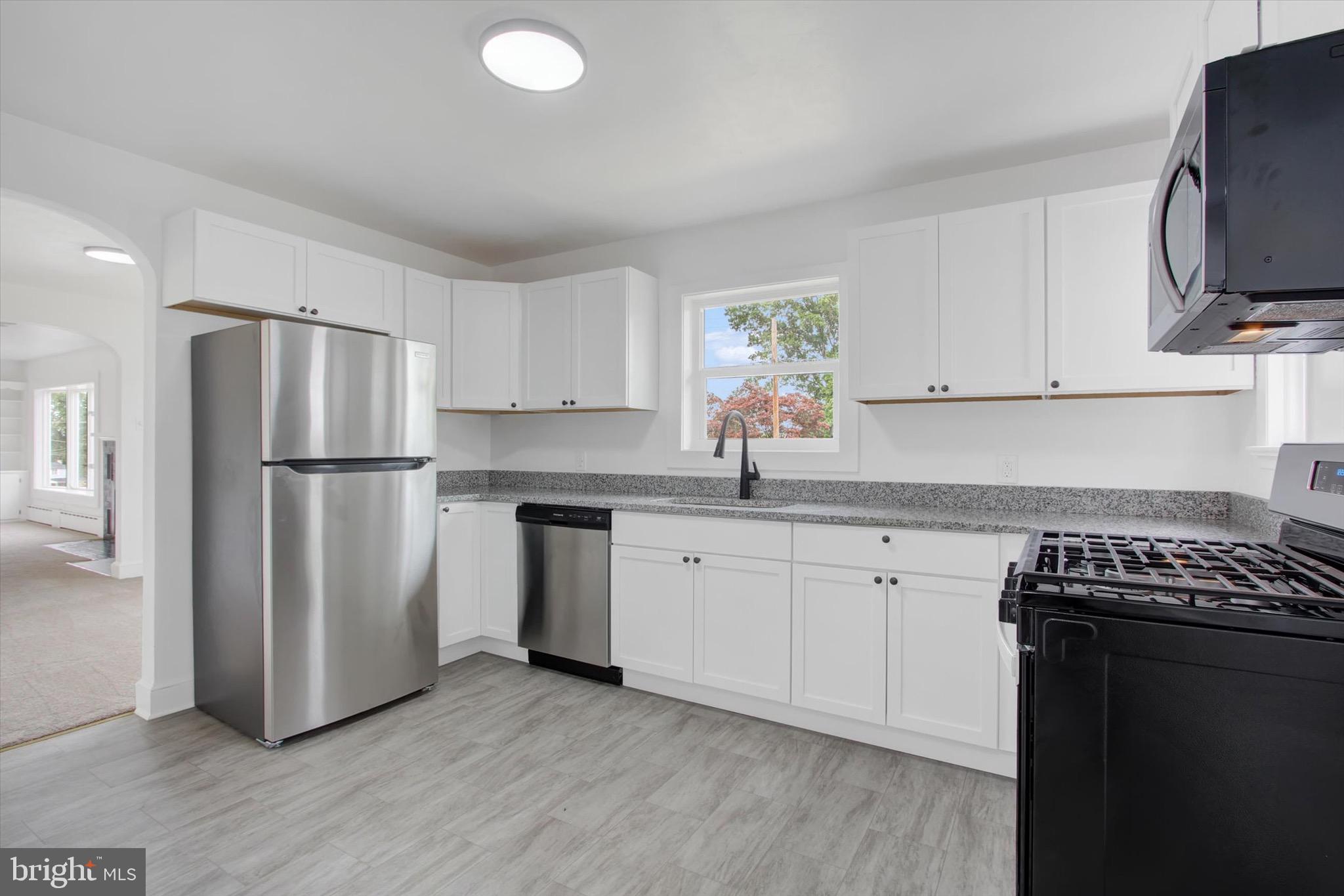 22 Rita Marie Avenue Littlestown, PA 17340 - Photo 13 of 34 a kitchen with stainless steel appliances granite countertop a refrigerator sink and stove