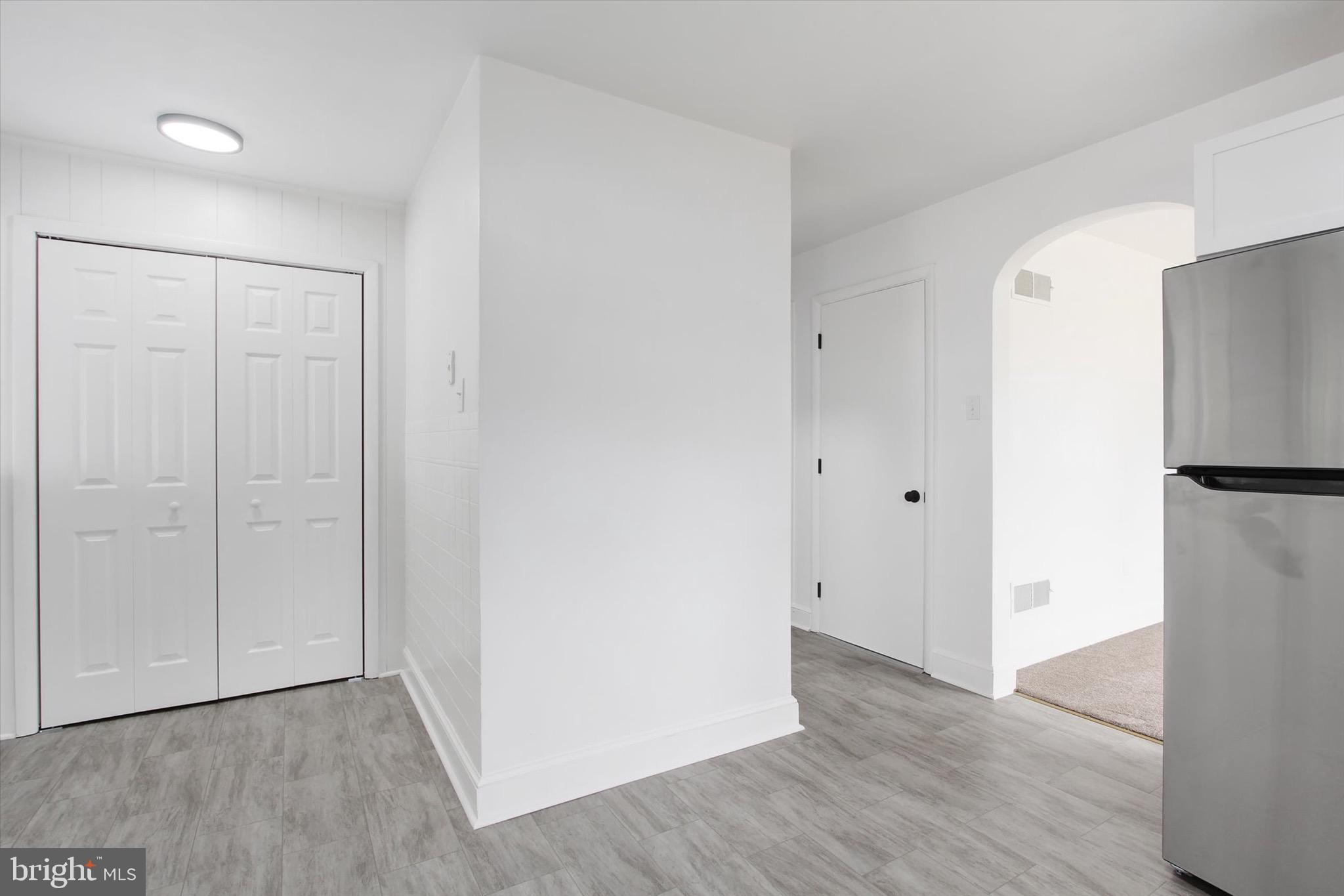 22 Rita Marie Avenue Littlestown, PA 17340 - Photo 15 of 34 a view of an empty room with wooden floor and a refrigerator