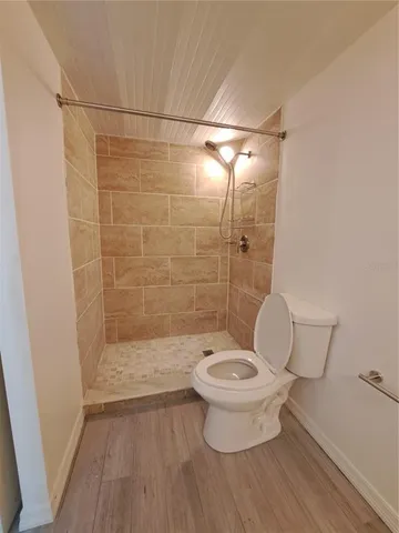 a bathroom with a toilet and a shower