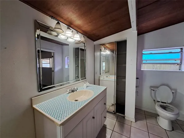 a bathroom with a granite countertop sink and mirror
