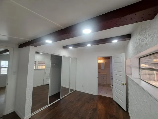 a view of hallway with stairs and wooden floor