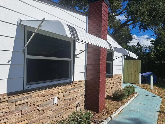 a backyard of a house with wooden floor and fence