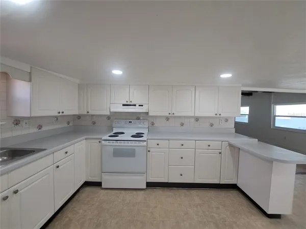 a kitchen with sink and cabinets