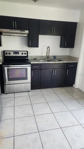 a kitchen with a sink and a stove