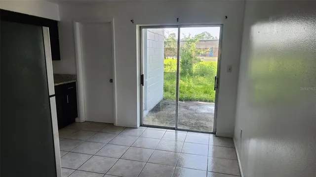 a view of an empty room and floor to ceiling window