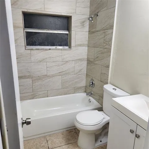 a bathroom with a sink a toilet and bathtub