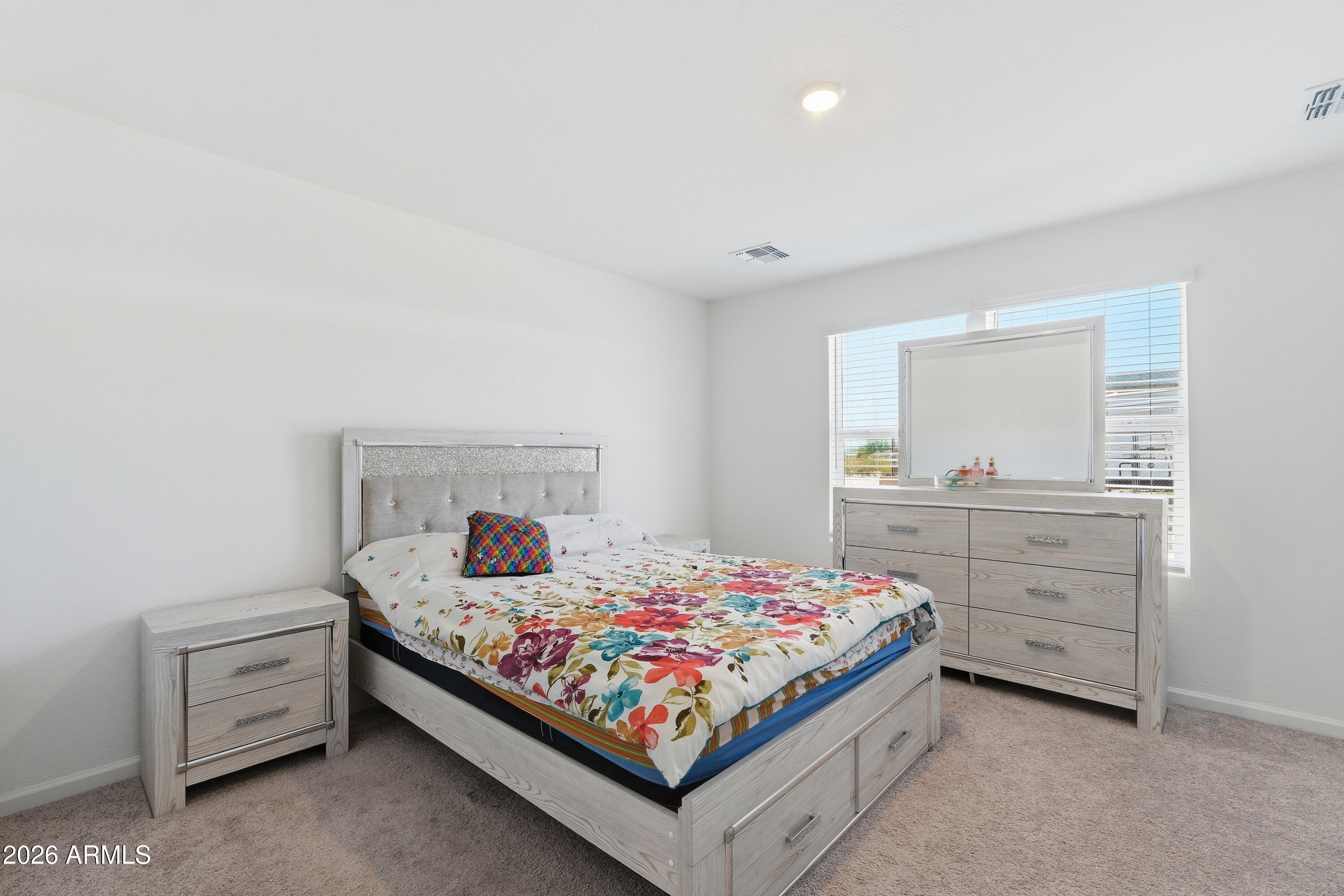 15610 South Moon Valley Road Arizona City, AZ 85123 - Photo 17 of 36 a bedroom with a bed and a dresser